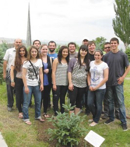 Prof. Barlow Der Mugrdechian, left, and students, with the tree they planted at the Armenian Genocide Memorial Grove. Photo: ASP Archive