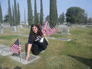 Marina Chardukian placing American flags on the graves of Veterans at Ararat Armenian Cemetery in Fresno Photo: ASP Archive
