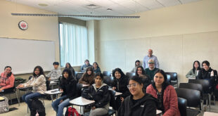 Prof. Barlow Der Mugrdechian, standing, with students from the Arts of Armenia course.